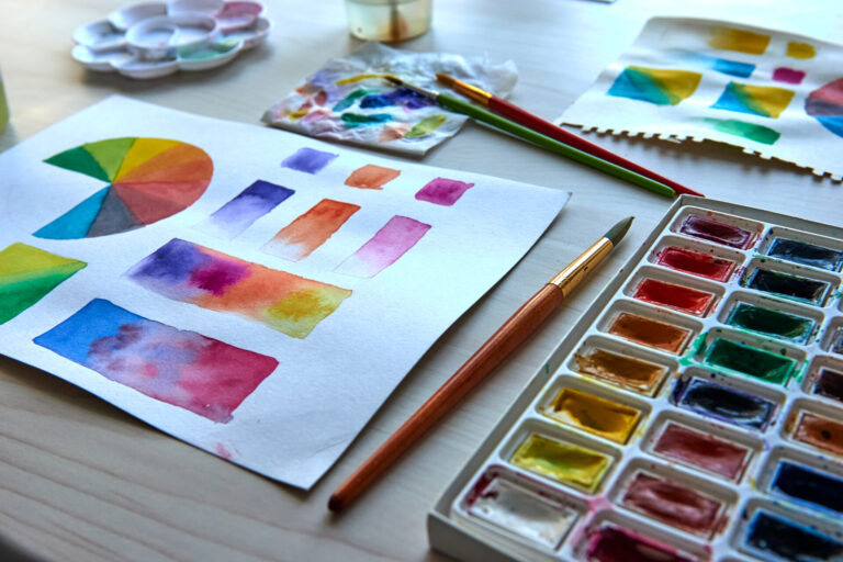 Artist's workplace. Art supplies brushes, paints, watercolors. Art studio. Drawing lessons. Creative workshop. Design place. Watercolor color wheel and palette